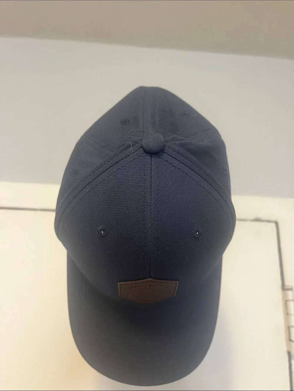 Travis Mathew Navy Blue Baseball Cap with Brown Hex Patch